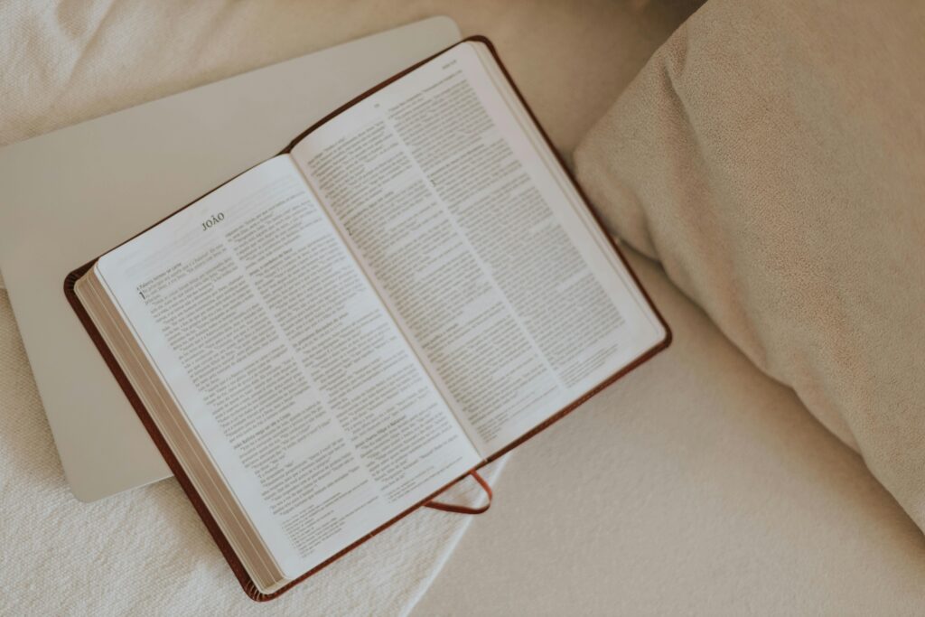 An open Bible on a beige blanket, inviting peaceful reflection and spiritual reading.